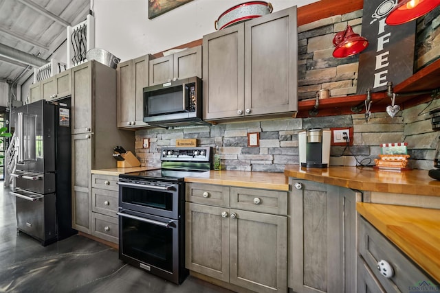 13391 County Road 4336, Larue, TX 75770 - kitchen featuring appliances with stainless steel finishes, wooden counters, backsplash, finished concrete flooring, and gray cabinets