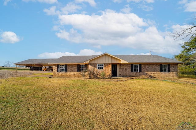 ranch-style house featuring a front yard and a carport