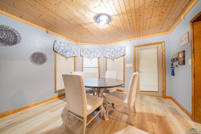 dining space with light wood-type flooring, ornamental molding, and wood ceiling