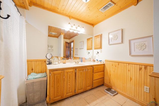 bathroom featuring vanity, wood walls, crown molding, tile patterned flooring, and wood ceiling