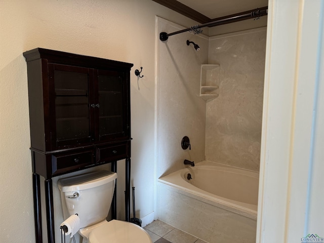 bathroom featuring tile patterned floors, tiled shower / bath combo, and toilet