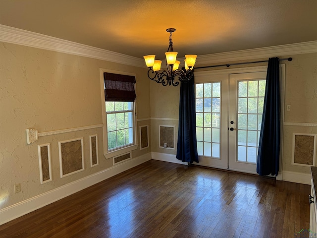 interior space featuring a chandelier, french doors, dark hardwood / wood-style flooring, and crown molding