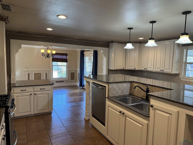 kitchen with pendant lighting, white cabinets, stainless steel appliances, and sink