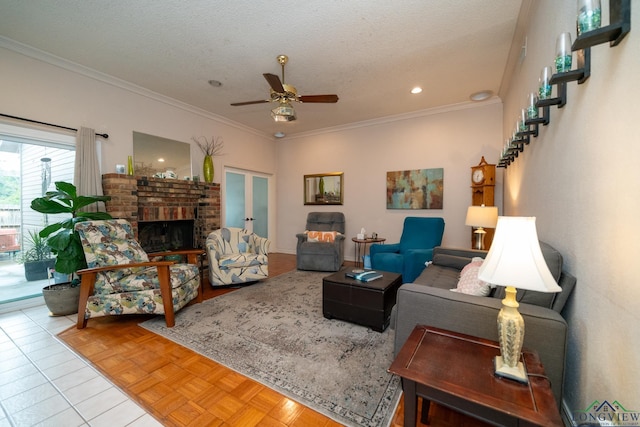 living room featuring ceiling fan, crown molding, light tile patterned floors, and a textured ceiling