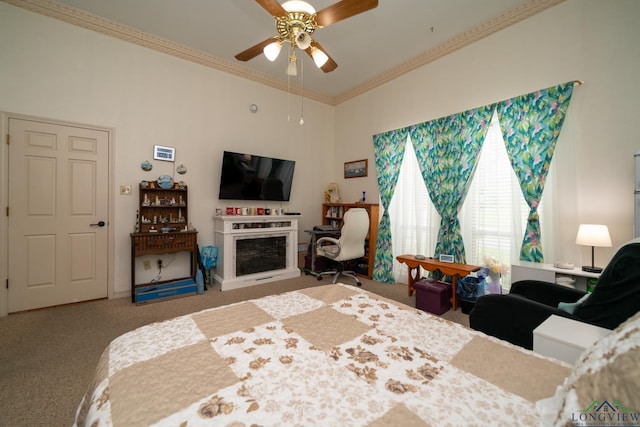 carpeted bedroom with ceiling fan and ornamental molding