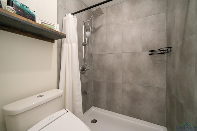 bathroom featuring toilet and a shower with shower curtain