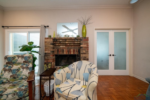 sitting room with crown molding, a fireplace, french doors, and parquet flooring