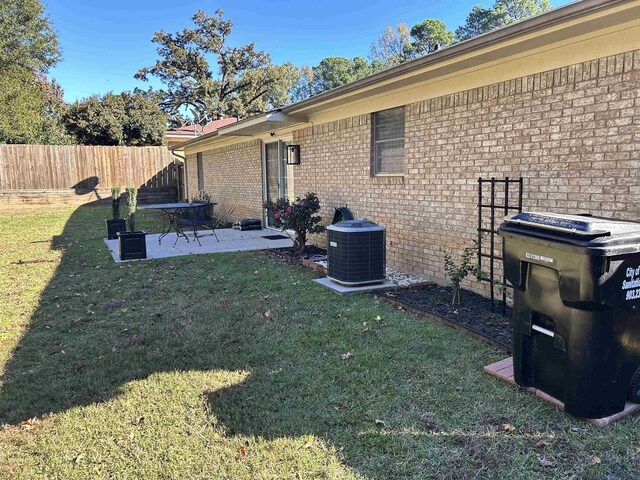 view of yard featuring central AC unit and a patio