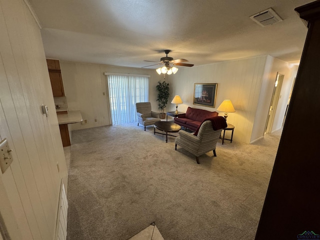 living room featuring ceiling fan and light colored carpet