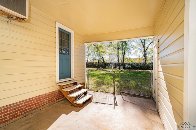 view of patio with an AC wall unit