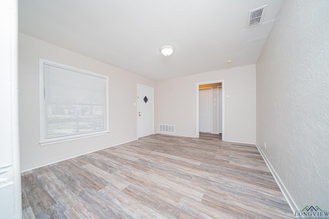 spare room with light hardwood / wood-style floors