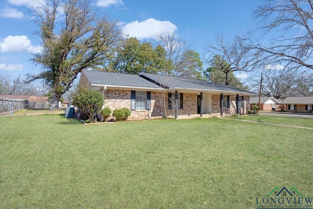 ranch-style house featuring fence, a front lawn, and brick siding