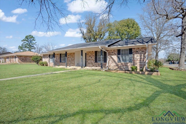 ranch-style house with a front yard and brick siding