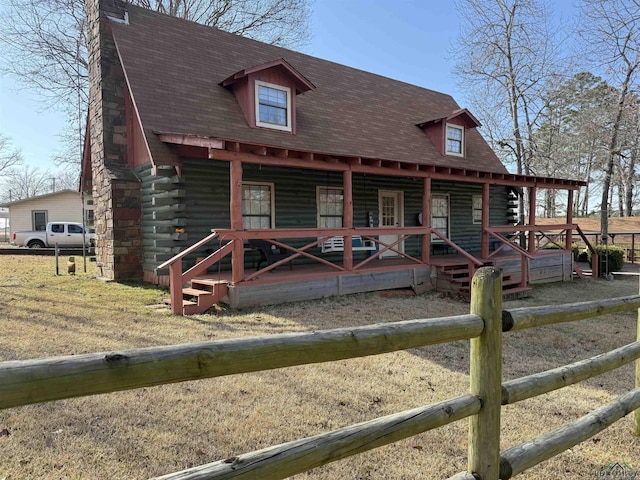 log cabin featuring covered porch, roof with shingles, and log siding