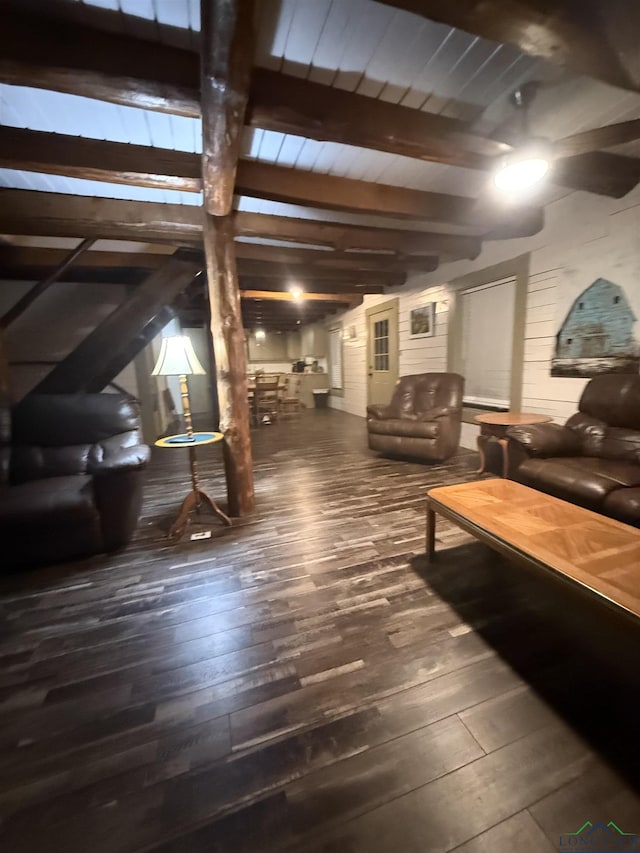 living room featuring dark wood-style floors and beamed ceiling