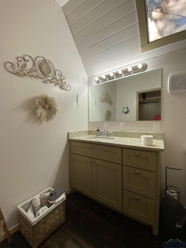 bathroom with baseboards, visible vents, lofted ceiling, wooden ceiling, and vanity