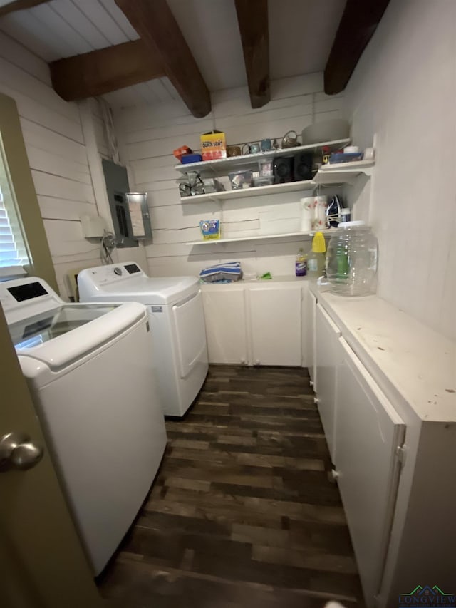 laundry area with dark wood-style floors, cabinet space, washing machine and dryer, wooden walls, and electric panel