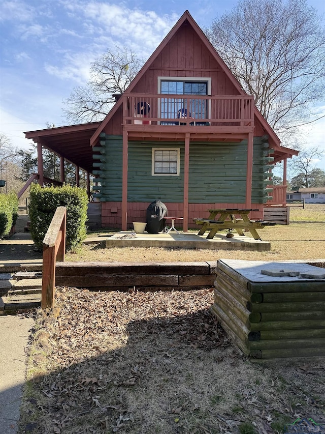 exterior space with a deck and log exterior