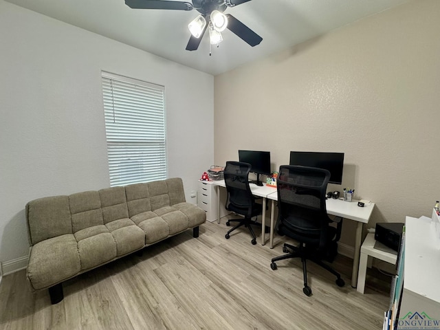 office featuring light wood finished floors, ceiling fan, and baseboards