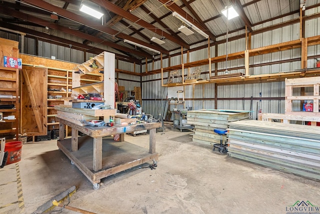 garage featuring a workshop area and metal wall