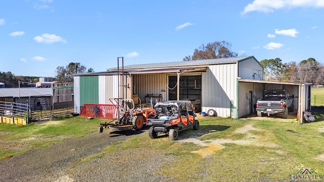 view of pole building featuring driveway and a carport