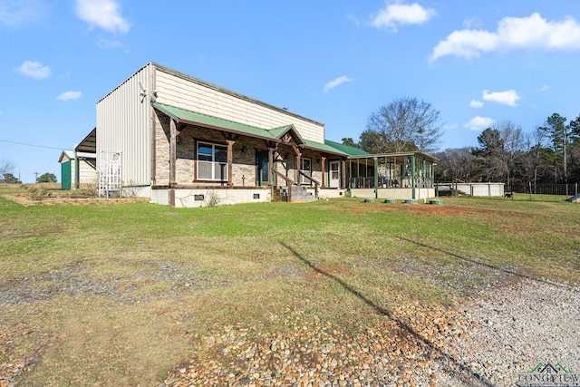 view of front of house featuring a sunroom, a front yard, and crawl space