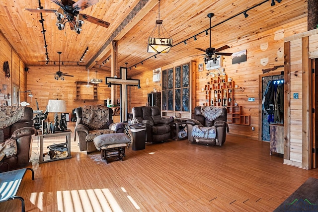 living room with wood walls and wood finished floors