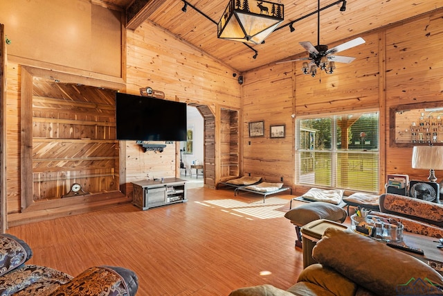 living room featuring high vaulted ceiling, wooden ceiling, wooden walls, wood finished floors, and a ceiling fan