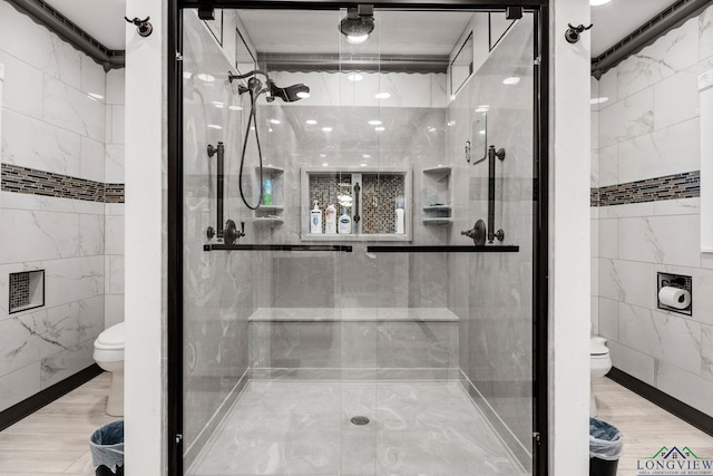 full bath featuring toilet, a shower stall, and tile walls