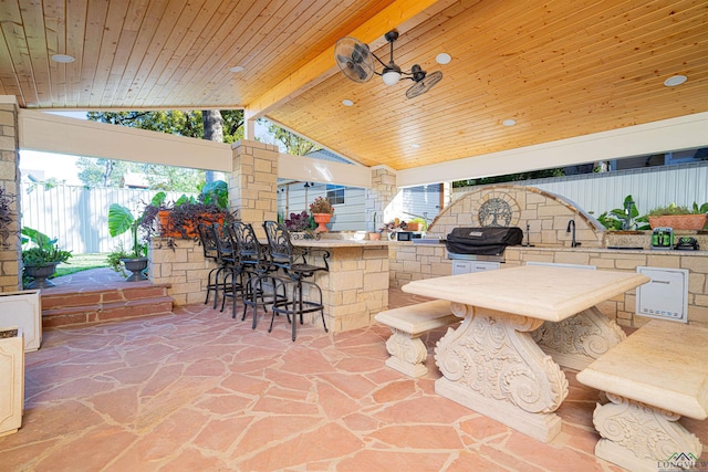 view of patio / terrace featuring area for grilling, an outdoor wet bar, and a grill