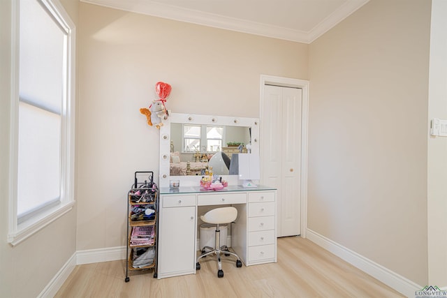 office space with crown molding, a healthy amount of sunlight, and light wood-type flooring