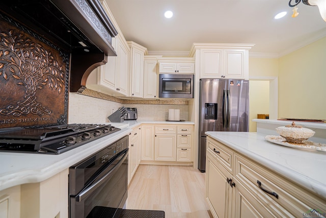 kitchen with light stone countertops, tasteful backsplash, crown molding, light hardwood / wood-style floors, and appliances with stainless steel finishes