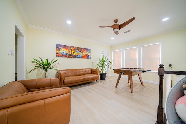 living room with ceiling fan, crown molding, and light hardwood / wood-style flooring