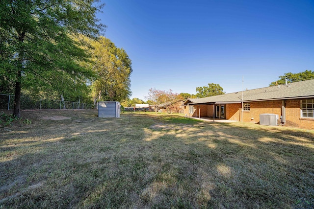 view of yard with cooling unit and a storage shed