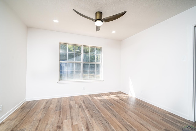 empty room with wood-type flooring and ceiling fan