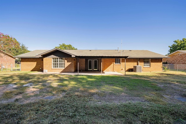 back of property with a patio, cooling unit, and a lawn