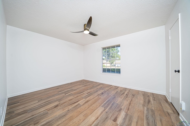 unfurnished room with hardwood / wood-style floors, ceiling fan, and a textured ceiling