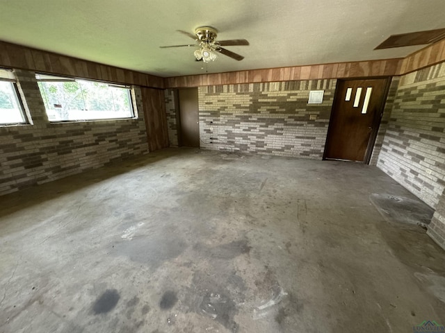 1258 County Road 4202, Daingerfield, TX 75638 - interior space featuring brick wall and concrete floors