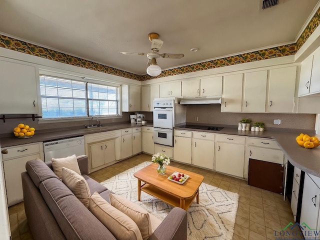 1258 County Road 4202, Daingerfield, TX 75638 - kitchen with white appliances, a ceiling fan, dark countertops, under cabinet range hood, and a sink