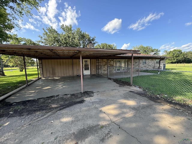 view of parking featuring a carport and fence