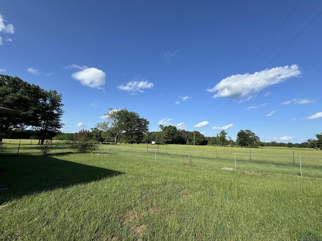 view of yard featuring a rural view and fence