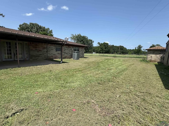 view of yard featuring a patio and central AC unit