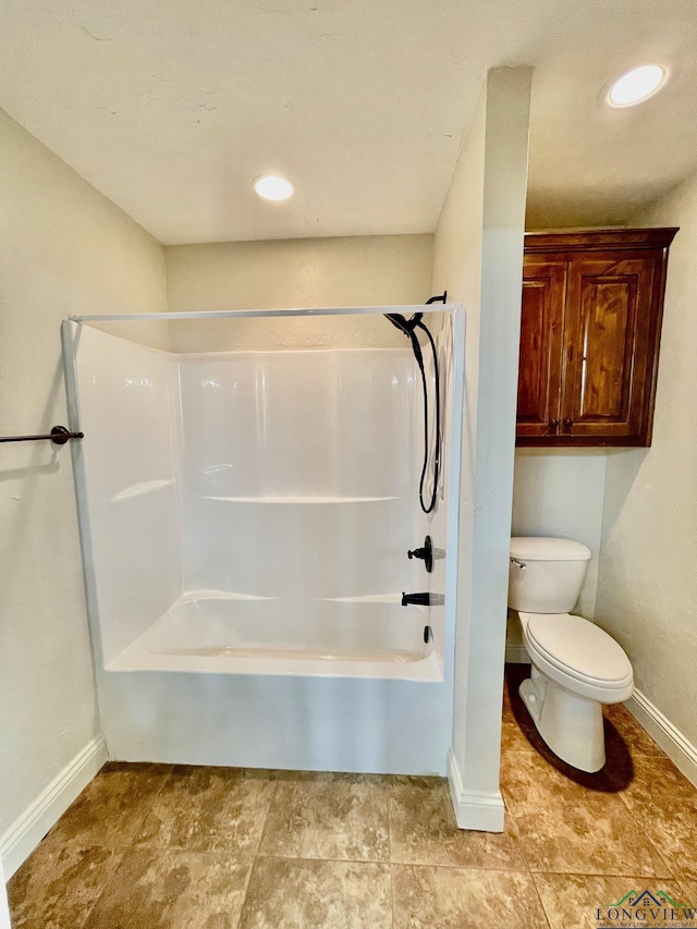 bathroom featuring toilet and  shower combination