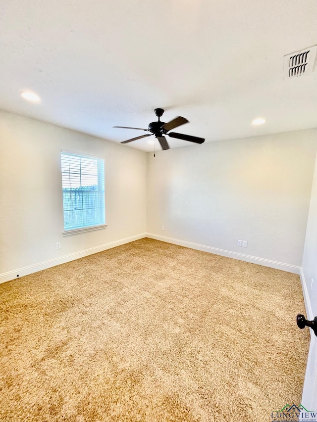 carpeted empty room featuring ceiling fan