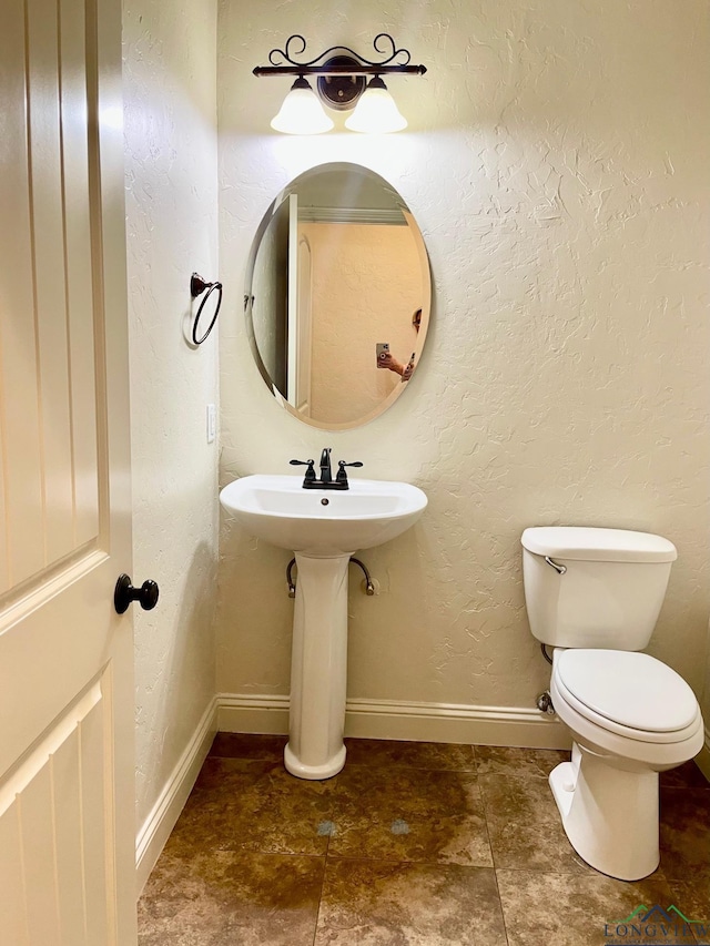 bathroom featuring toilet and sink