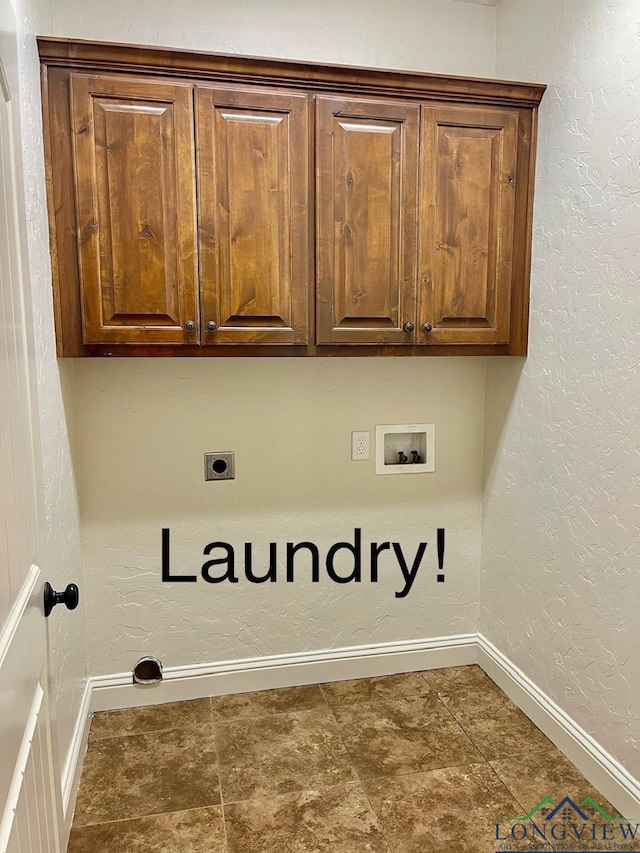 laundry room featuring electric dryer hookup, hookup for a washing machine, and cabinets