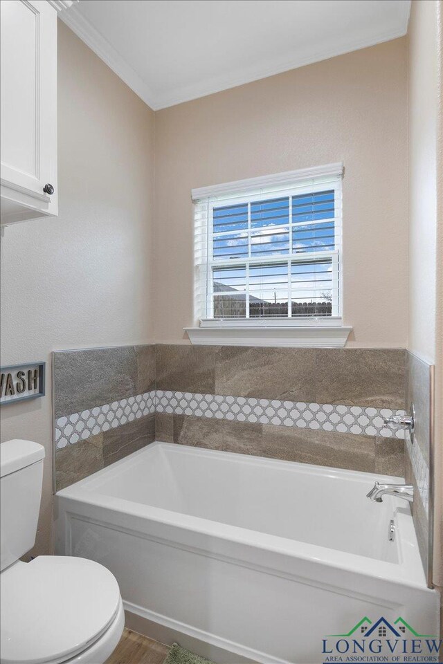 204 Nolan Farms, Winona, TX 75792 - bathroom with toilet, a bathing tub, and crown molding