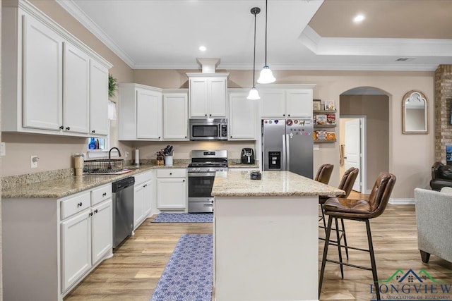 204 Nolan Farms, Winona, TX 75792 - kitchen featuring appliances with stainless steel finishes, a kitchen island, white cabinetry, and decorative light fixtures