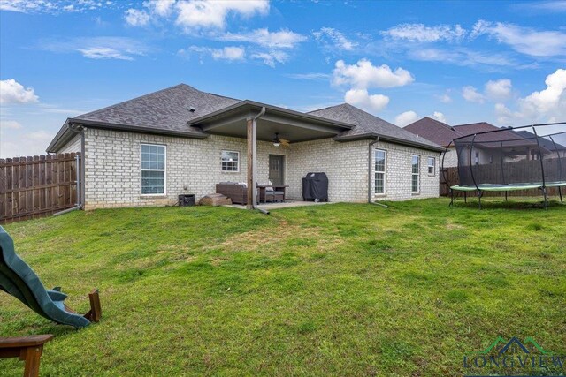 204 Nolan Farms, Winona, TX 75792 - rear view of house with a yard, a trampoline, and a patio area