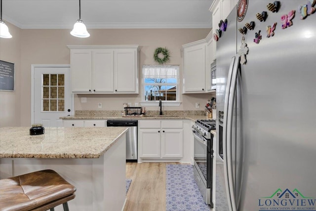 204 Nolan Farms, Winona, TX 75792 - kitchen featuring white cabinetry, stainless steel appliances, and decorative light fixtures
